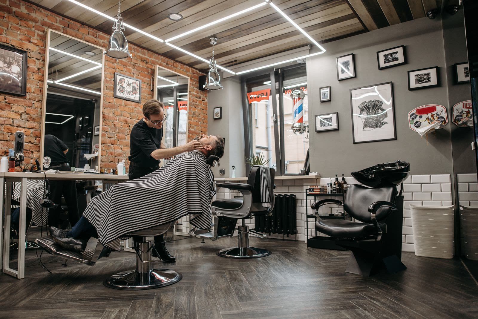 Barber shaping a beard at Vesper Barbers