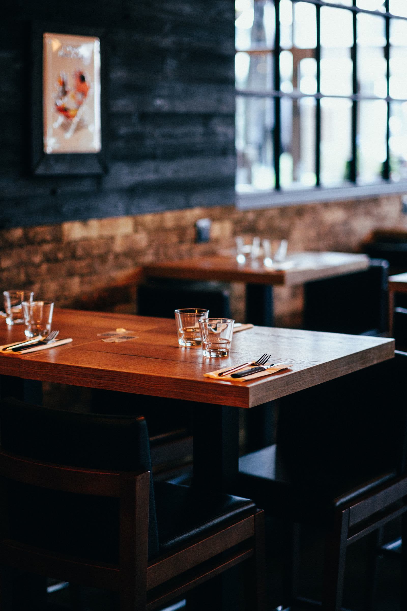 Warmly lit interior of Trattoria Lucia with set tables